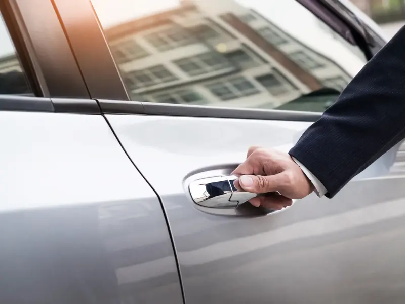 Chauffeur opening a car door